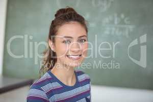 Portrait of happy schoolgirl in classroom