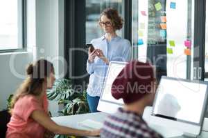 Female executive using mobile phone in office