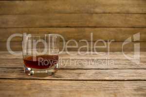 Glass of whisky on wooden table