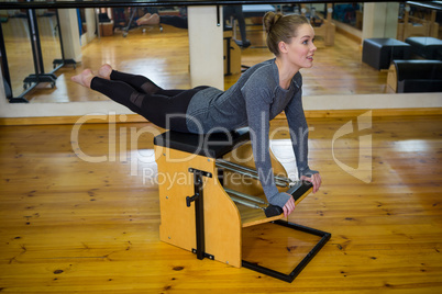 Beautiful woman exercising on wunda chair