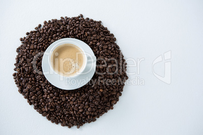 Cup of coffee with roasted coffee beans