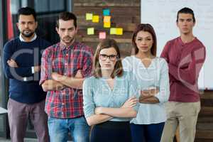 Portrait of businesspeople standing with arms crossed