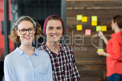 Smiling business executives standing in office