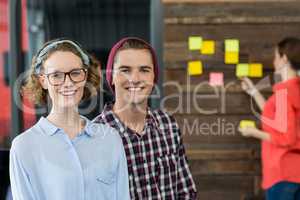 Smiling business executives standing in office
