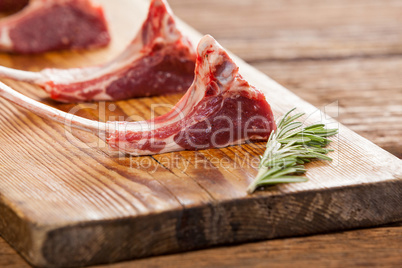 Rib chops and rosemary herb on wooden tray