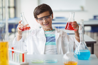 Portrait of schoolboy doing a chemical experiment in laboratory