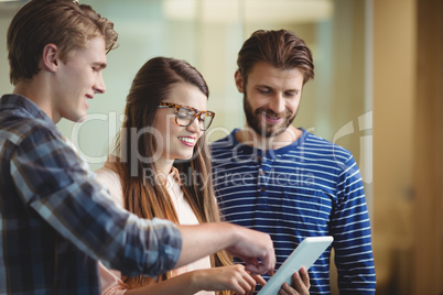 Executives using digital tablet in office