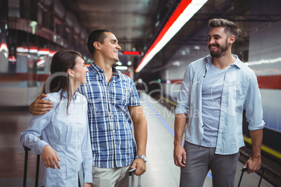 Executives interacting on platform while travelling