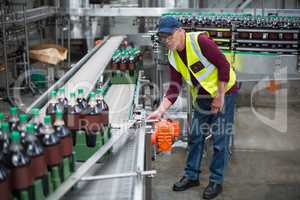 Male factory worker inspecting production line