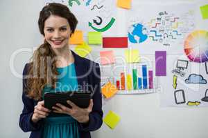 Smiling woman holding digital tablet