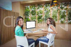 Business executive sitting at desk together