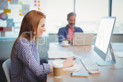 Female executive working on computer