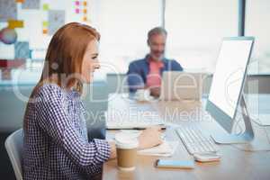 Female executive working on computer