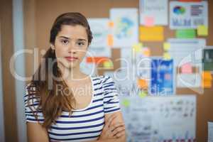 Portrait of female business executive standing with arms crossed