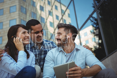 Executives listening music on digital tablet