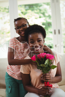 Daughter with arms around mother shoulders