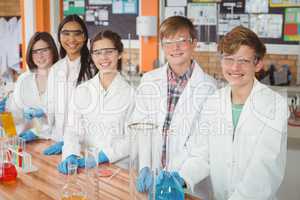 Portrait of school kids doing a chemical experiment in laboratory