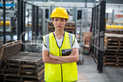 Portrait of female worker standing with arms crossed