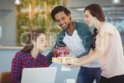 Business executives celebrating their colleagues birthday