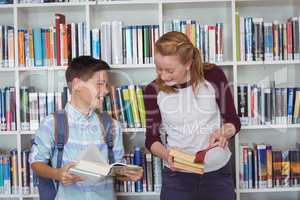 Happy students reading books in library