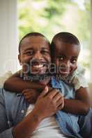 Son embracing his father at home