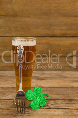 Glass of beer, fork and shamrock for St Patricks Day
