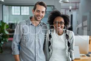 Happy man and woman standing in office