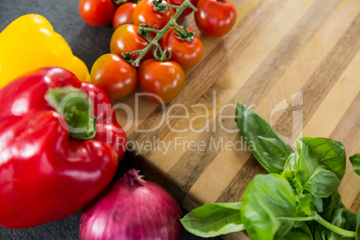 Wooden and vegetables against black background