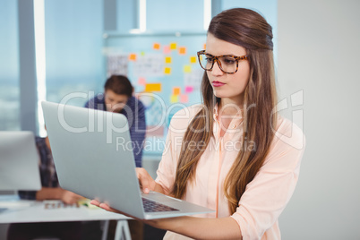 Female business executive using laptop