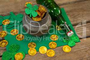 St. Patricks Day shamrock, beer bottle and pot filled with chocolate gold coins