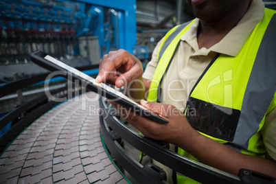 Factory worker using digital tablet in the factory