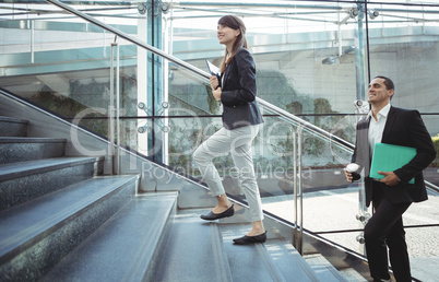 Businesses executives walking on stairs outside platform