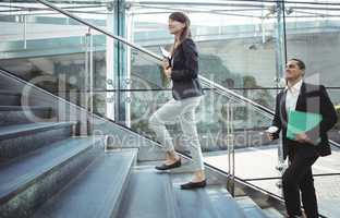 Businesses executives walking on stairs outside platform