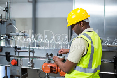 Factory worker operating machine in factory