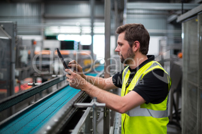 Factory worker using a digital tablet in factory