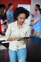 Business executive using digital tablet at meeting