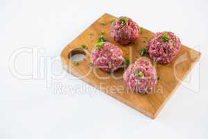 Minced beef on wooden tray