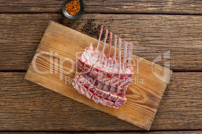 Rib rack on wooden board with spices