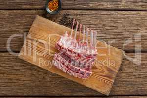 Rib rack on wooden board with spices