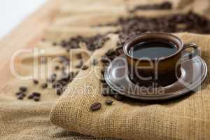 Black coffee served on sack with coffee beans