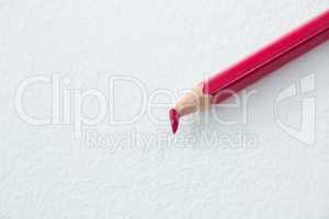 Red colored pencil with broken tip