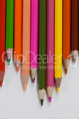 Close-up of colored pencils arranged in a wave pattern