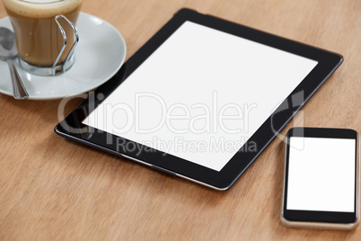 Digital table and mobile phone with cup of coffee