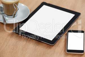 Digital table and mobile phone with cup of coffee