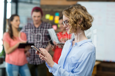 Business executive using mobile phone in office