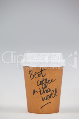 Disposable coffee cup with written text on white background