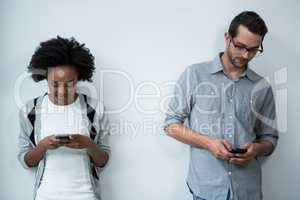 Man and woman using mobile phone