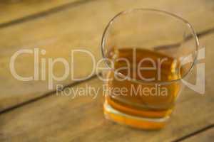 Glass of whisky on wooden table