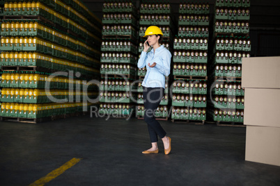 Female factory worker talking on mobile phone