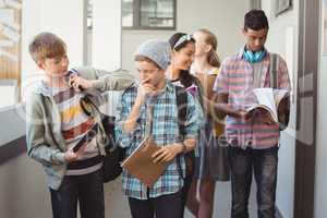 Group of classmate walking in corridor